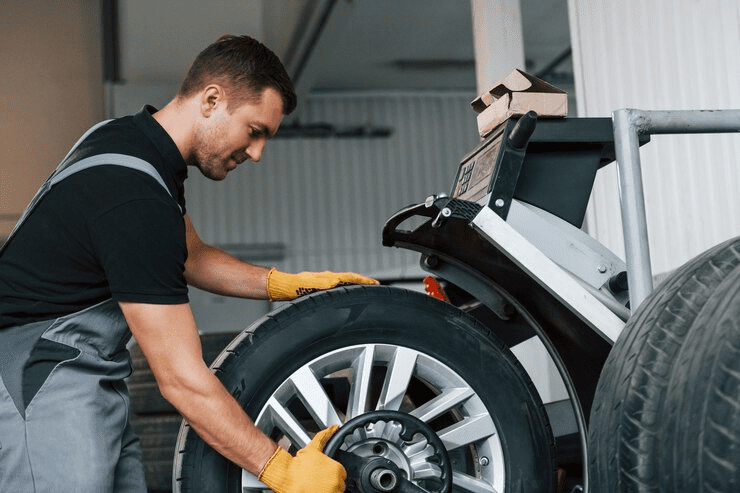 Taking the wheel Man in uniform is working in the auto service